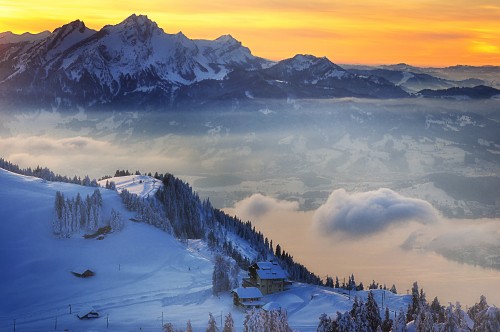 Image snow covered mountain under cloudy sky during daytime