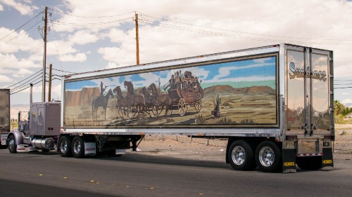 Image black and brown trailer truck on road during daytime