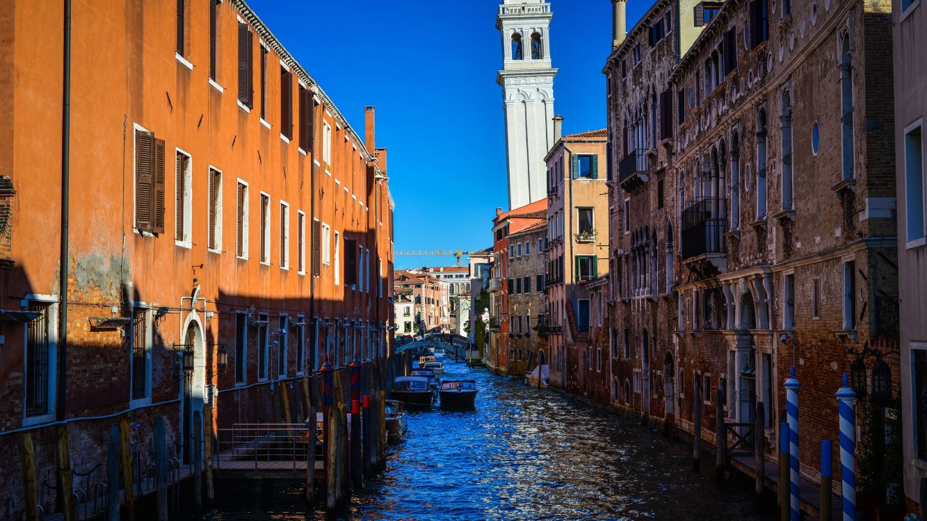 river between brown concrete buildings during daytime