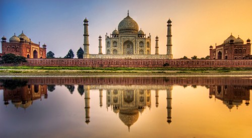 Image white and brown dome building near body of water during daytime