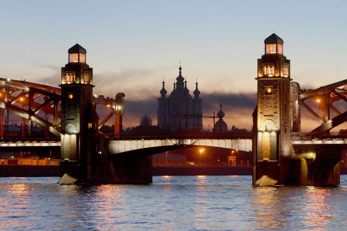 brown concrete bridge over river during sunset