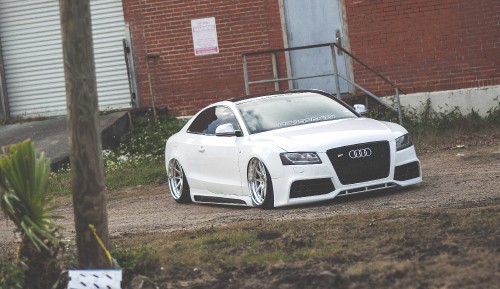 Image white audi r 8 parked near brown brick building