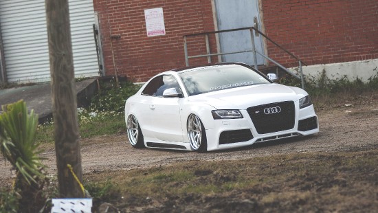 Image white audi r 8 parked near brown brick building