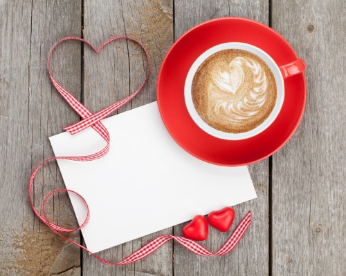 Image white and red ceramic mug on red ceramic plate