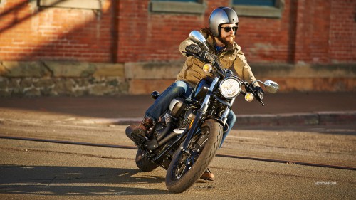 Image man in black helmet riding motorcycle on road during daytime