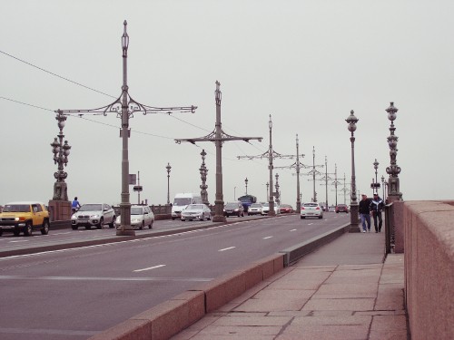 Image people walking on sidewalk near street light posts during daytime