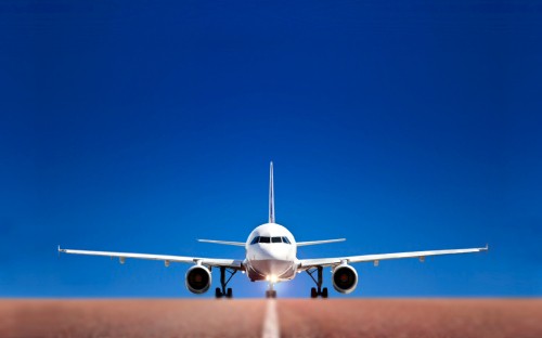 Image white airplane in mid air during daytime