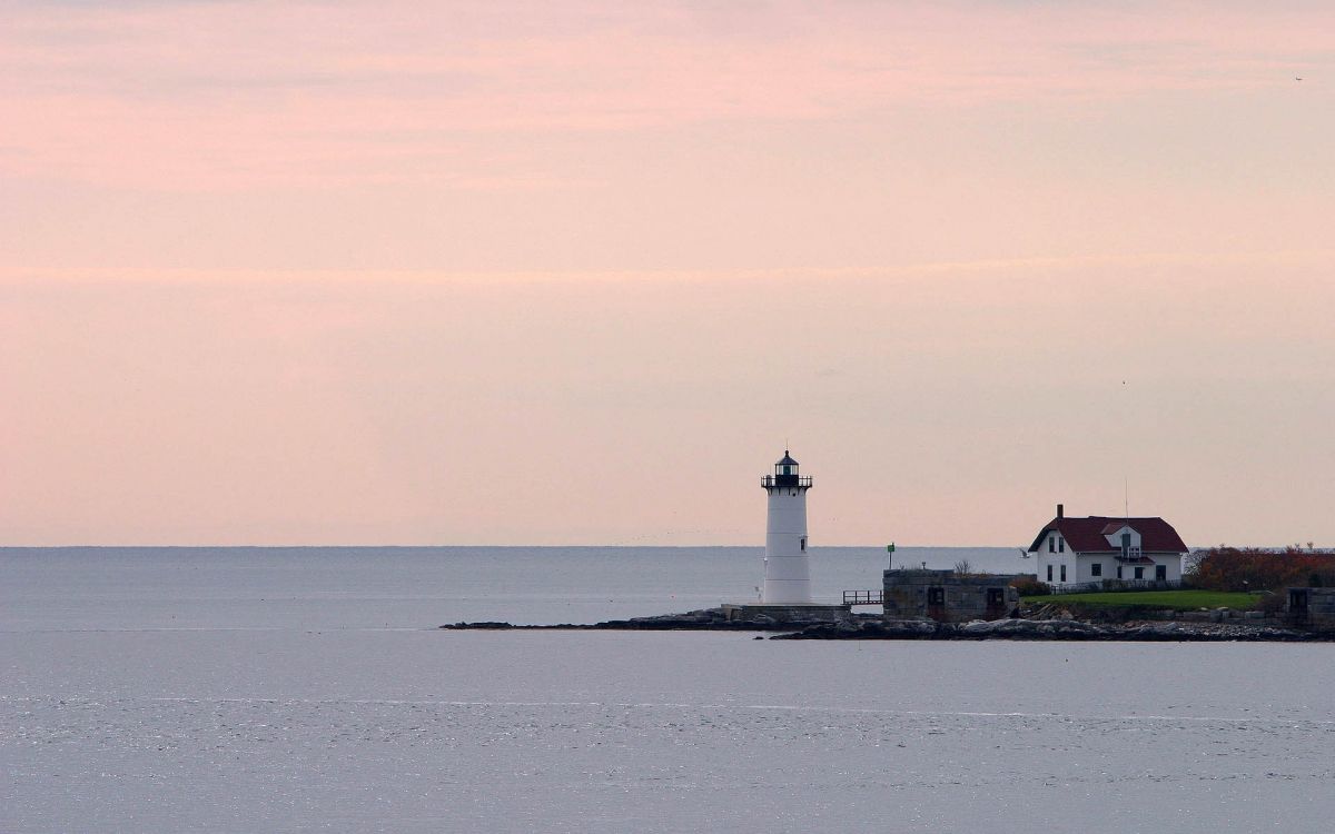 white and black lighthouse on island during daytime