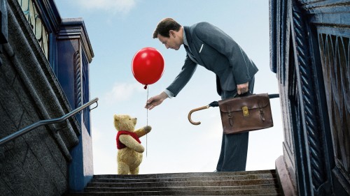 Image man in black jacket and black pants holding red balloons