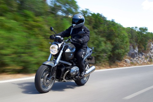 Image man in black helmet riding motorcycle on road during daytime