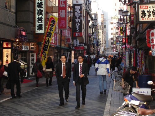 Image people walking on sidewalk during daytime