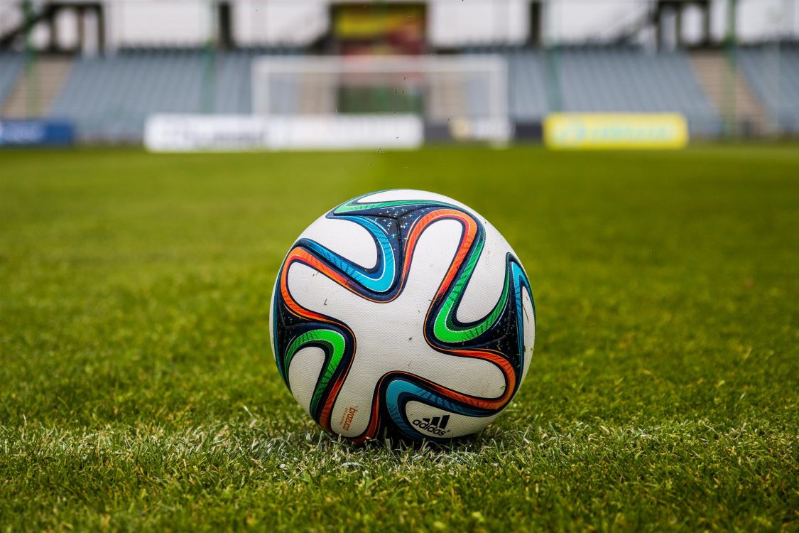 White Blue and Red Soccer Ball on Green Grass Field During Daytime. Wallpaper in 3000x1999 Resolution