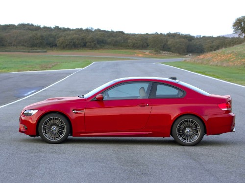 Image red coupe on gray asphalt road during daytime