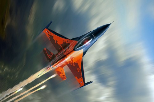 Image orange and gray jet plane in mid air