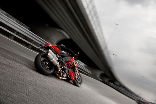 Image red and black motorcycle on road