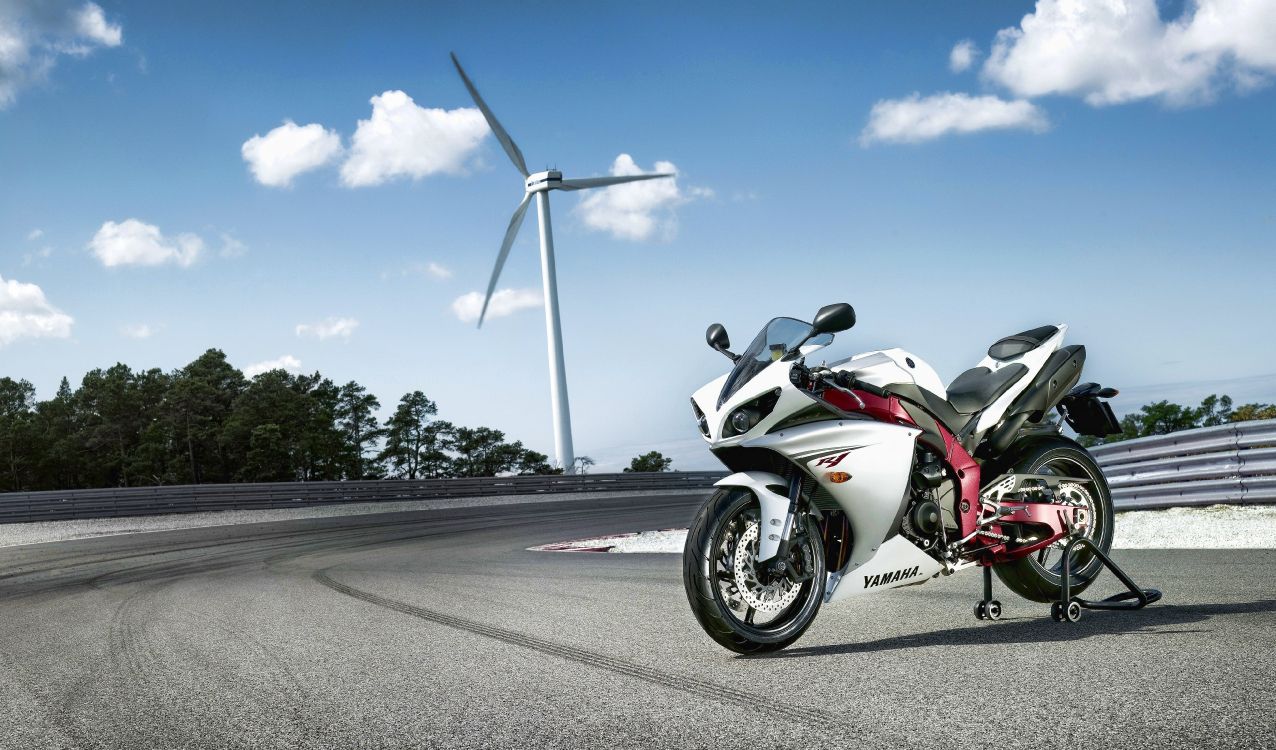 white and red sports bike on road during daytime