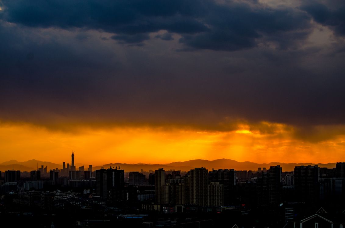 silhouette of city buildings during sunset