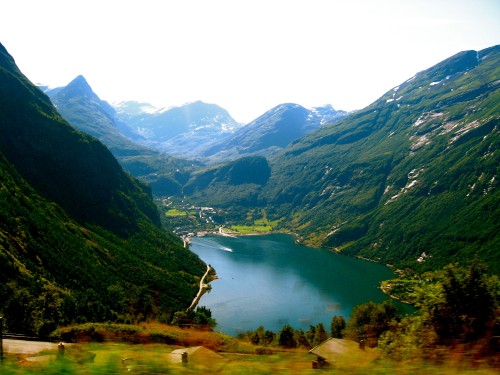 Image green mountains near lake under white sky during daytime