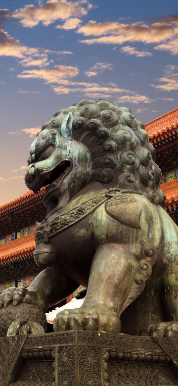 Image gray concrete statue of man with wings under blue sky during daytime