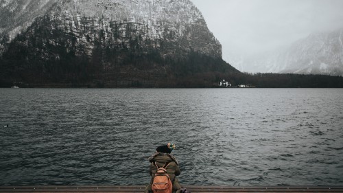 Image man in black and yellow goggles riding boat on lake during daytime