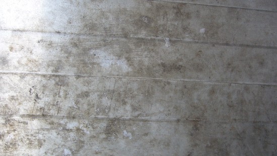 Image person in black shoes standing on gray concrete floor