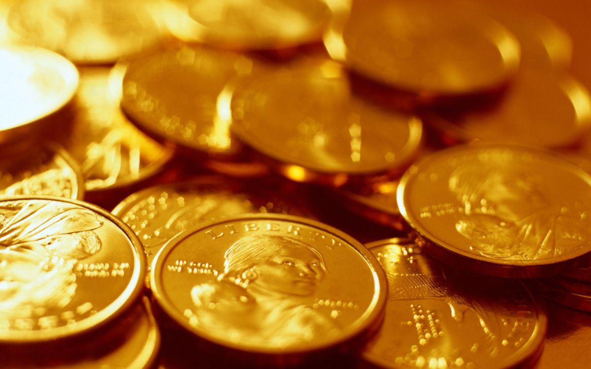 silver round coins on brown wooden table