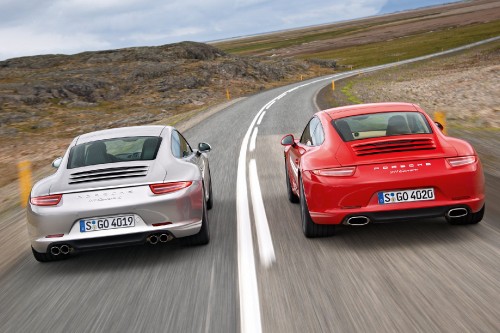 Image red and white porsche 911 on road during daytime