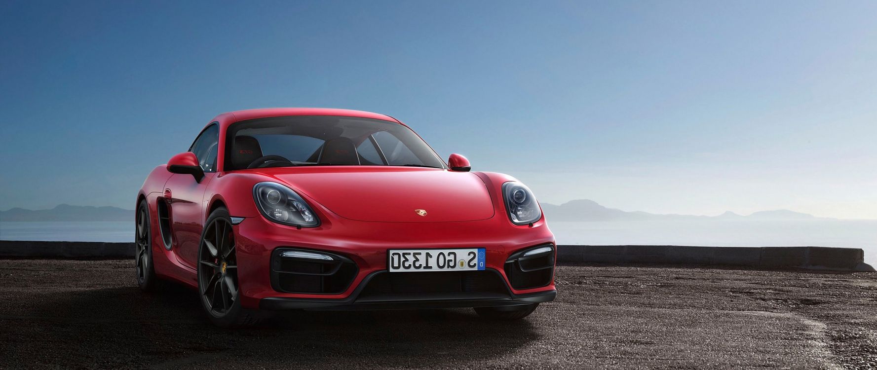 Roter Porsche 911 Auf Schwarzer Asphaltstraße Tagsüber. Wallpaper in 2560x1080 Resolution