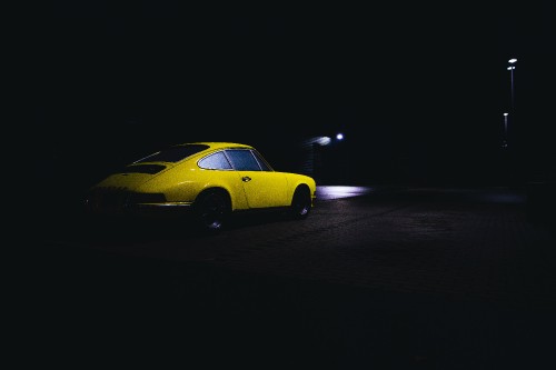 Image yellow coupe on black asphalt road during night time