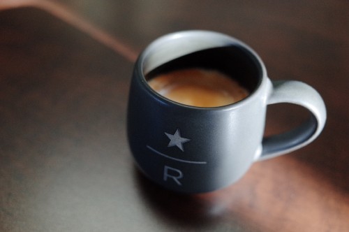 Image black and white ceramic mug with brown liquid