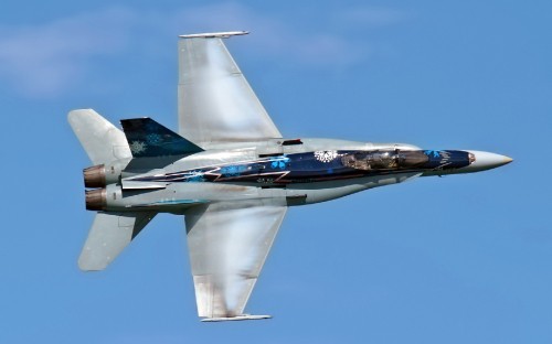 Image gray jet plane in mid air during daytime