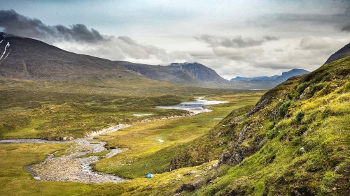 Image green grass covered mountain under cloudy sky during daytime