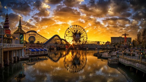 Image red ferris wheel beside river under cloudy sky during daytime