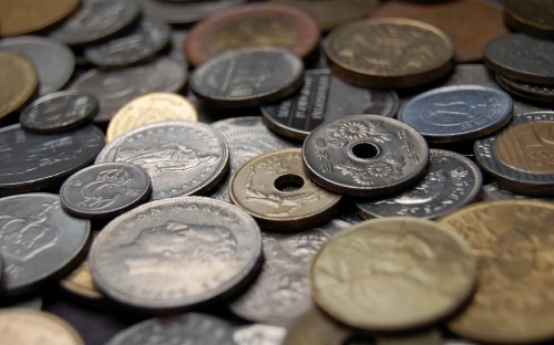 Image silver round coins on black surface