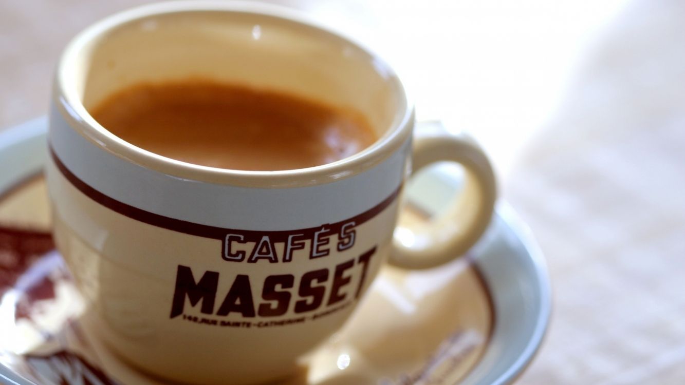 white ceramic mug with brown liquid