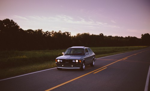 Image black sedan on road during daytime