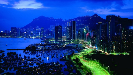 Image city skyline near body of water during night time