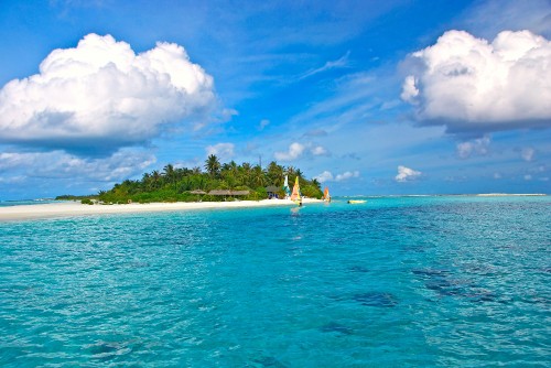 Image people in white and green boat on blue sea under blue and white cloudy sky during