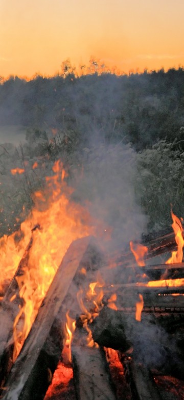 Image bonfire near lake during daytime