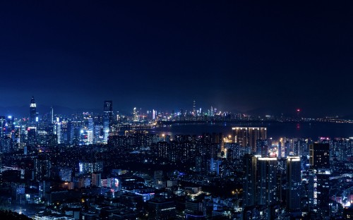 Image city with high rise buildings during night time