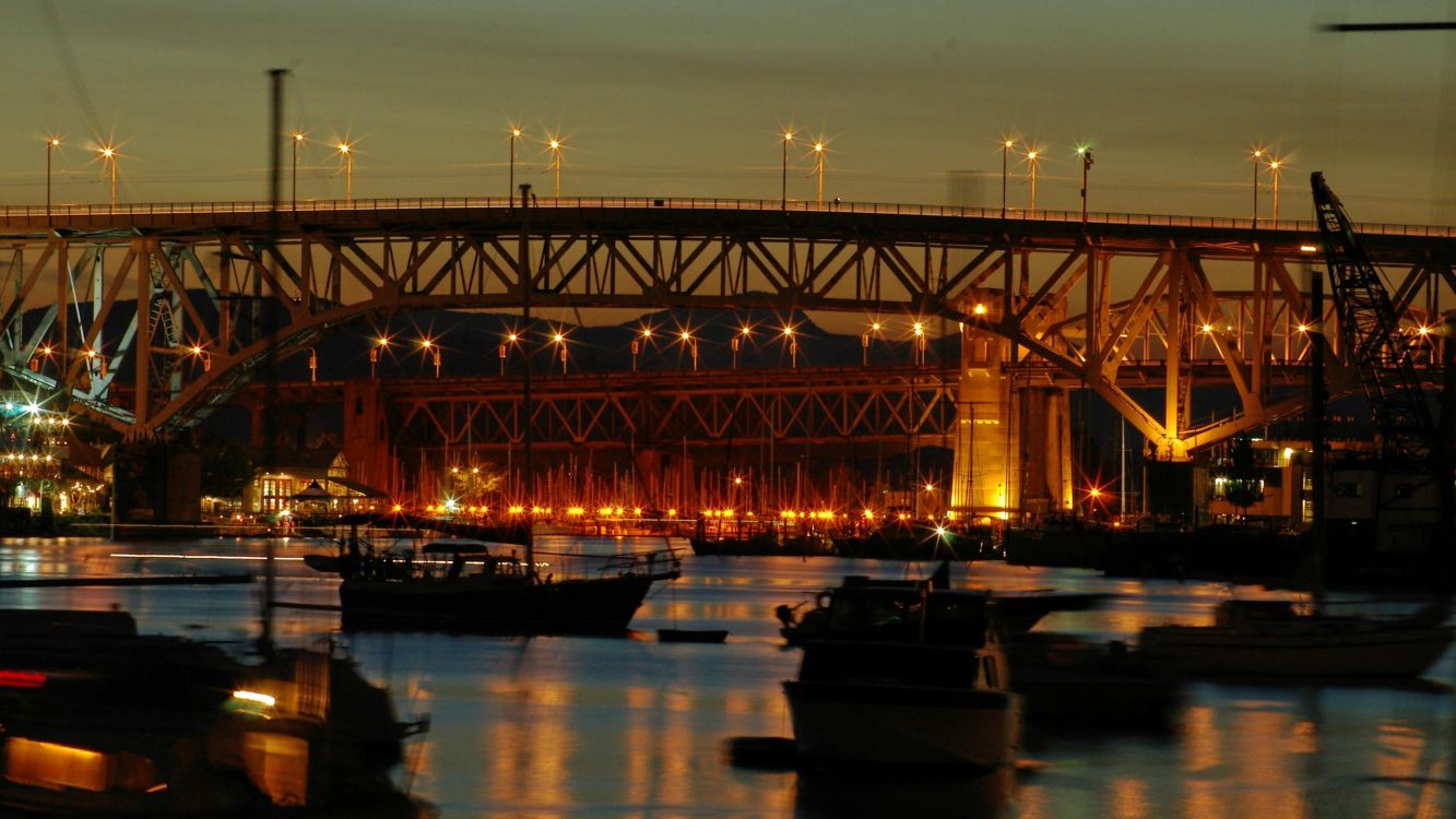 boat on water near bridge during night time