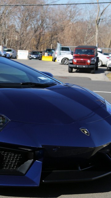 Image blue porsche 911 parked on parking lot during daytime