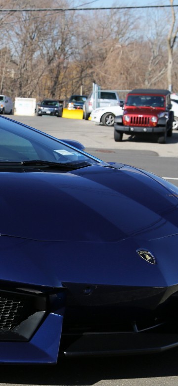 Image blue porsche 911 parked on parking lot during daytime