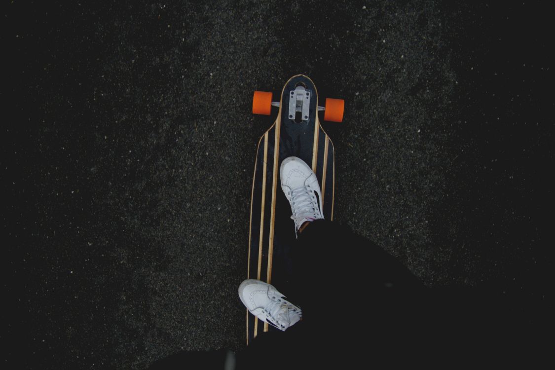 Person in Black Pants and White Sneakers Riding on Brown Wooden Skateboard. Wallpaper in 5184x3456 Resolution