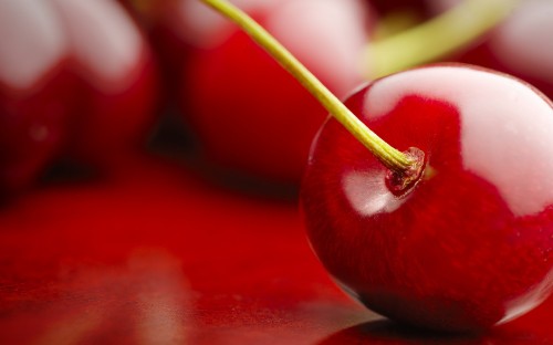 Image red cherry fruit on red table