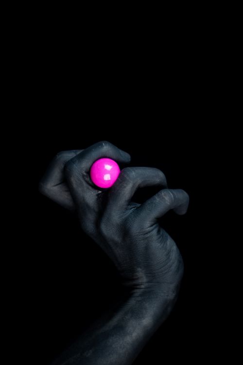 person holding red round ornament