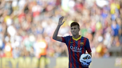 Image boy in red and blue soccer jersey raising his hands