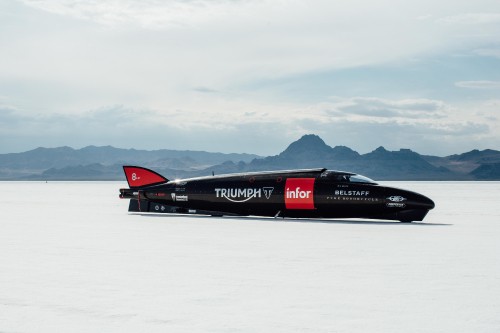 Image red and black jet plane on snow covered ground during daytime