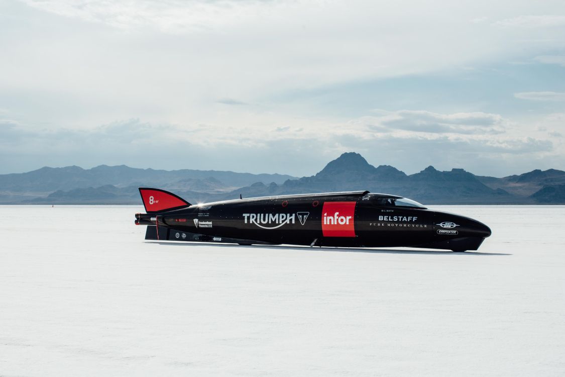 red and black jet plane on snow covered ground during daytime