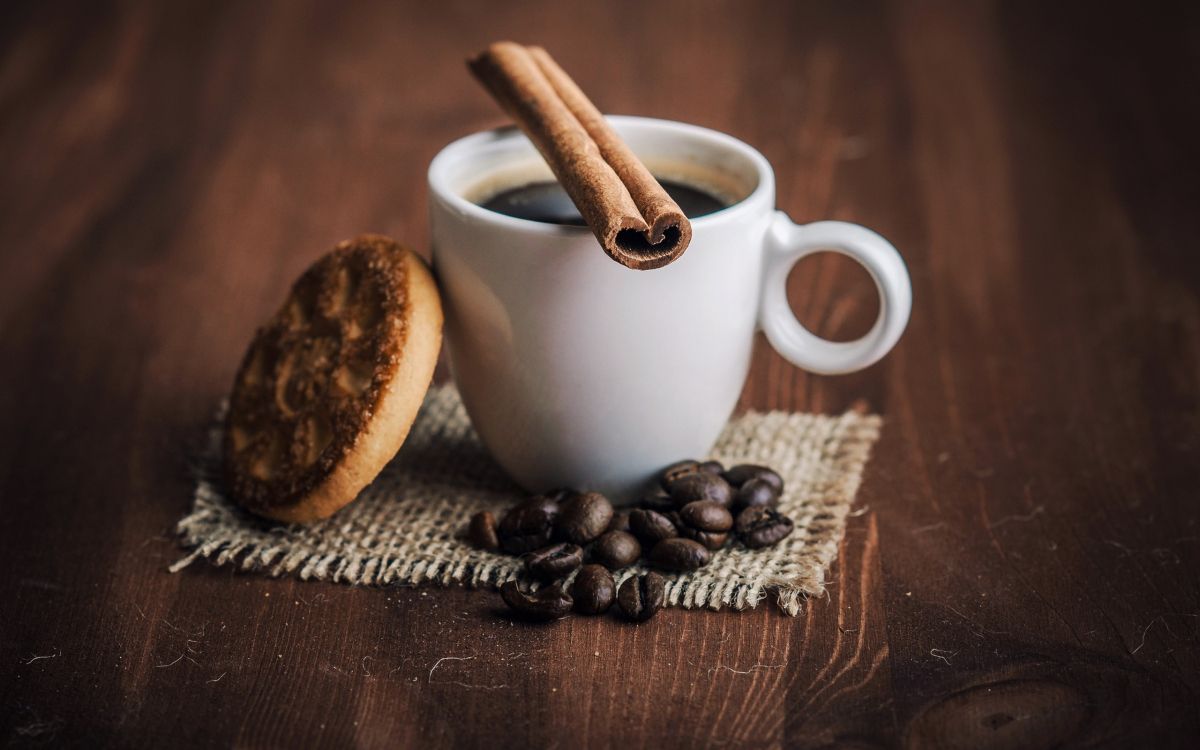 white ceramic mug with coffee beans